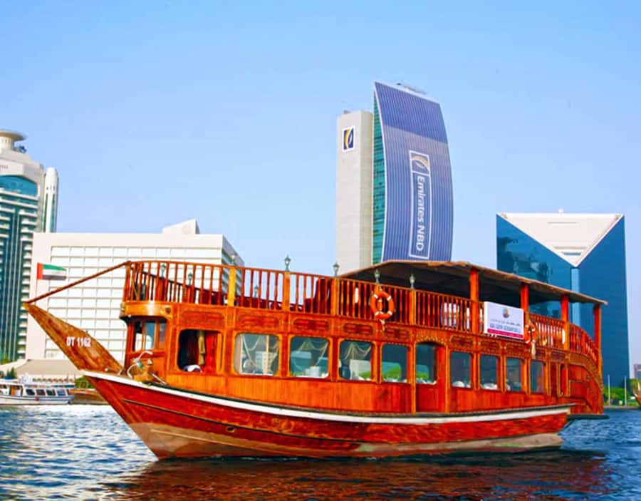 Dubai: Dhow Dinner Cruise on Creek or Marina with Live Shows - Boarding a traditional wooden dhow