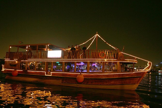 Evening Dhow Dinner Cruise in Dubai - Boarding a light-festooned wooden dhow