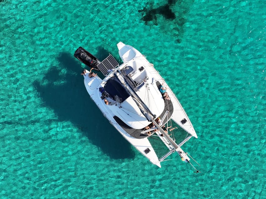 From Ornos: Mykonos Delos Catamaran Cruise with Meal & SUP - Sunset sailing back toward Mykonos
