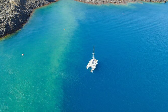 Full Day Santorini Catamaran Private Cruise with meal and transfer - White Beach: a quieter cove reached only by sea