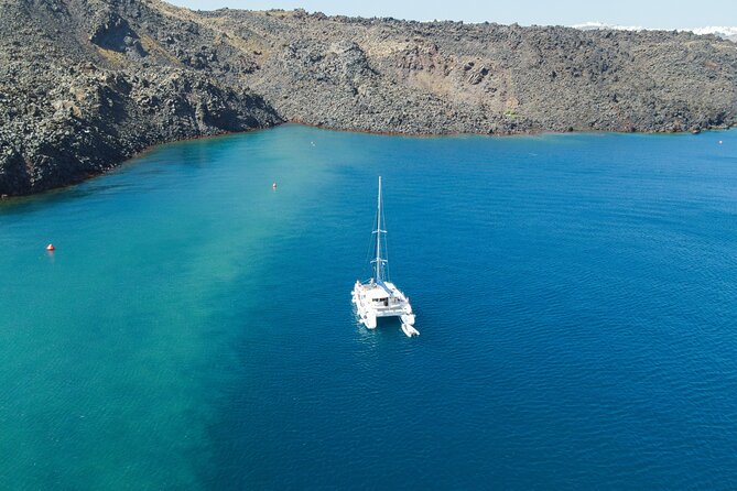 Full Day Santorini Catamaran Private Cruise with meal and transfer - Faros lighthouse and the Indian Head rock