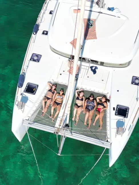 Majorca: Dinner aboard a private catamaran with snorkeling and paddle surfing - Seafood dinner as the sun goes down
