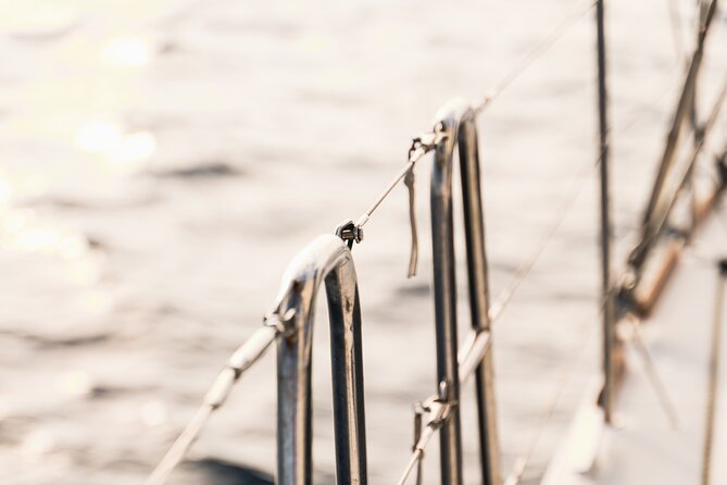 Mykonos Catamaran Sunset Cruise with Meal, Drinks & Transfer - The sunset and Mykonos after dark