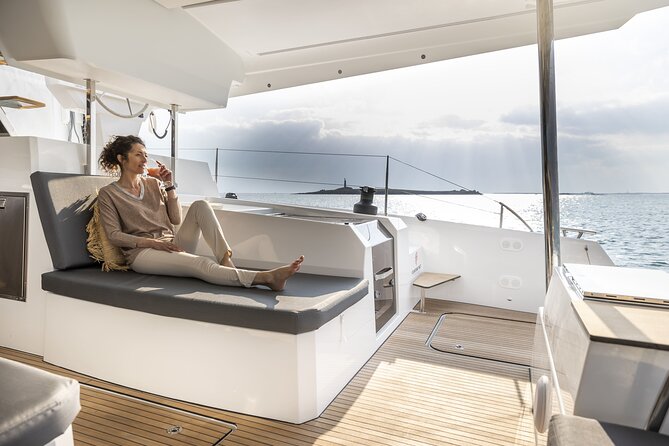 Mykonos: Luxury Catamaran Cruise with Meal, Drinks & Transport - A possible view of Delos, without a shore visit