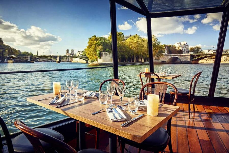 Paris: 3-Course Lunch Cruise on the River Seine - A glass-enclosed view of Paris
