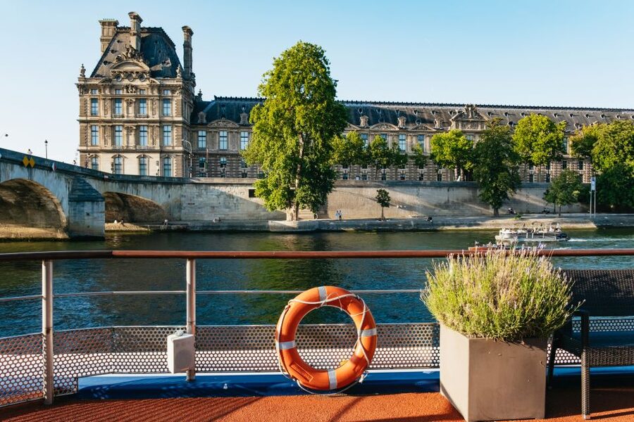 Paris: Seine River Panoramic Views Dinner Cruise - A dinner table with Paris outside the window