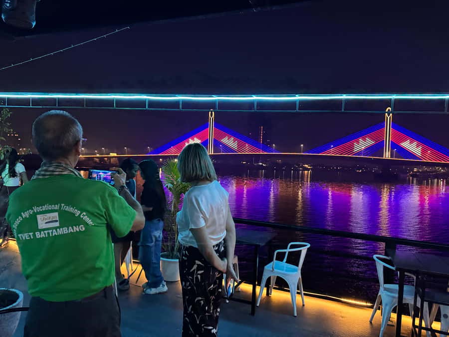 Phnom Penh: Sunset Dinner Cruise with English Speaking Guide - Stilted homes, fishing areas, and crops by the shore