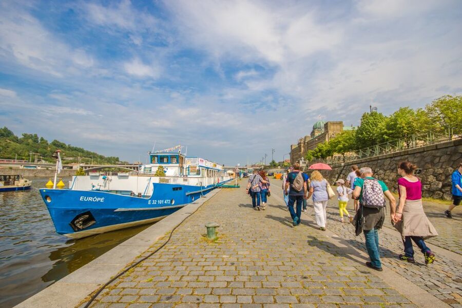 Prague: Guided Bus & Walking Tour with River Cruise & Lunch - Walking toward Charles Bridge and the Old Town