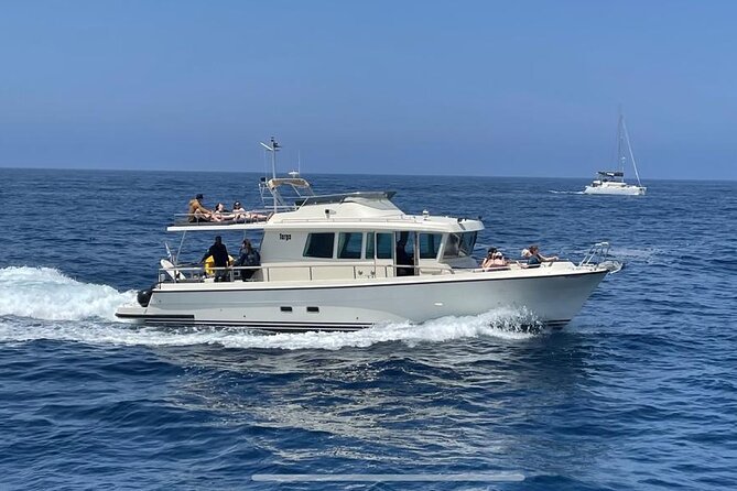 Private Full-Day Motor Yacht Cruise with Meal, Open Bar+Transfers - Red Beach and White Beach: striking scenery, limited space