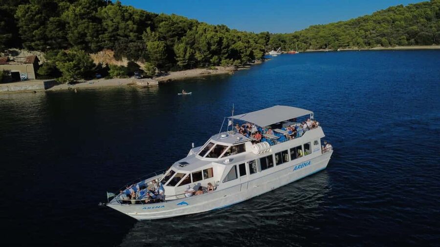 Pula: Brijuni Dolphins Sunset Cruise with Dinner and Drinks - The Brijuni coastline at golden hour
