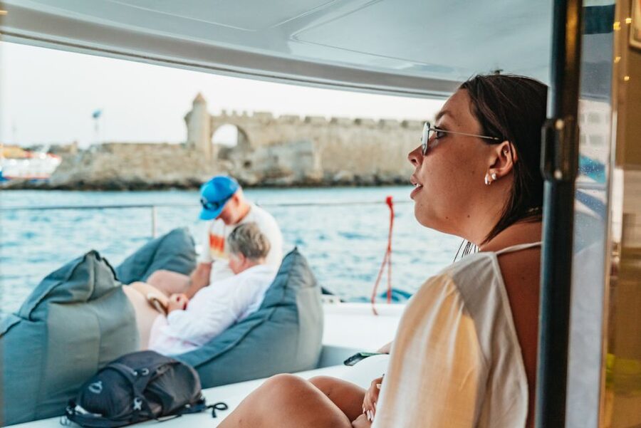 Rhodes: Sunset Catamaran Cruise with Dinner Buffet & Drinks - Catching the sunset near Rhodes Town