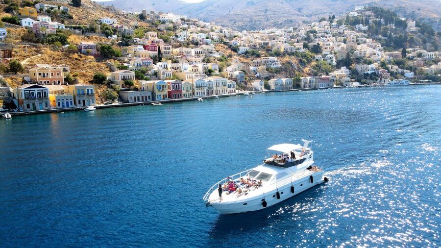 Rhodes: Symi Yacht Tour with Unlimited Drinks and Transfer - Arriving in Symi Town by water