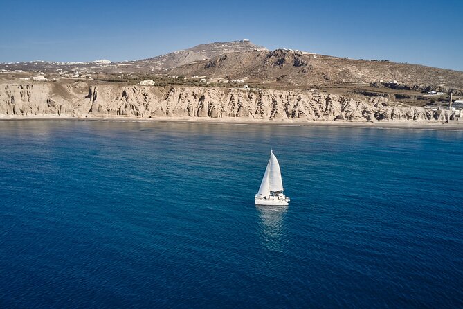 Santorini: Caldera Private Catamaran Cruise with Meal & Drinks - Red Beach and the island’s scarlet volcanic rock