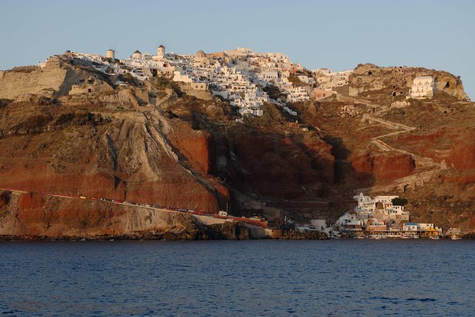 Santorini Caldera Sunset Sailing Cruise with Dinner and Wine - Sunset near Oia, seen from the water