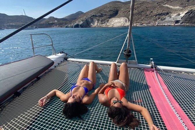 Santorini Catamaran Cruise – 5-Hour Private Sailing Experience - The lighthouse adds a quieter coastal view