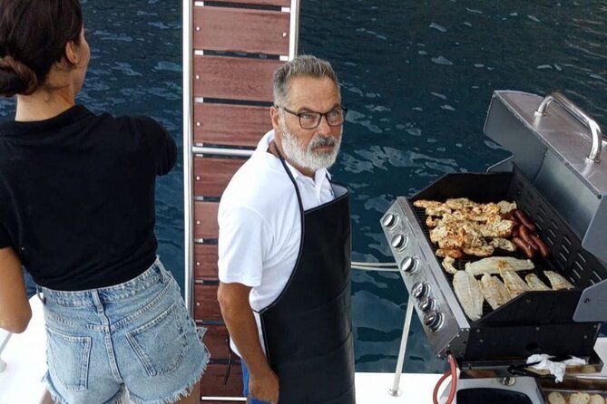 Santorini Catamaran Cruise with Meal and Drinks - Swimming and snorkeling in a private bay