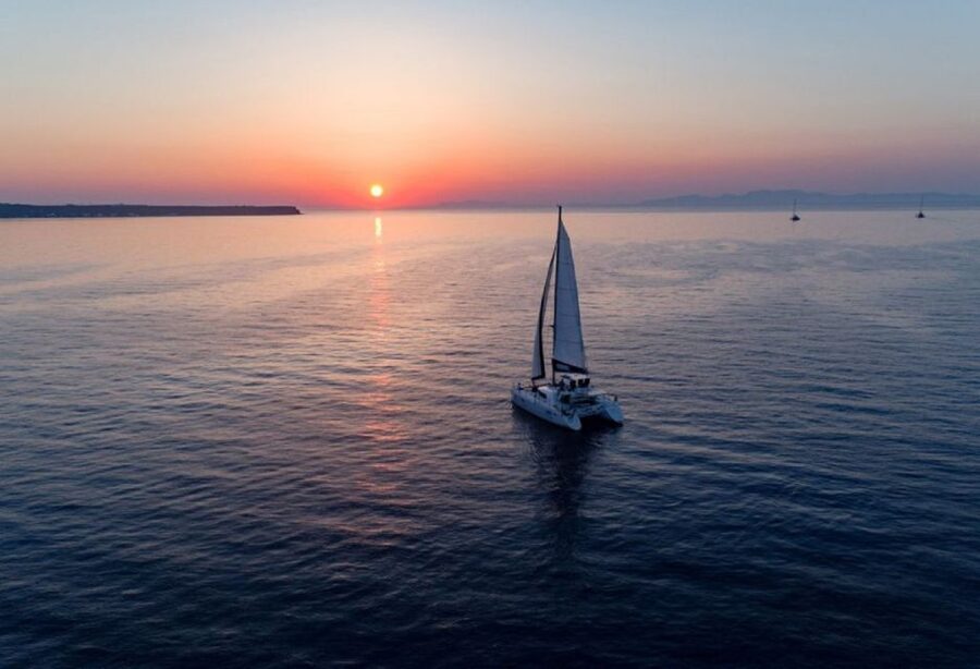 Santorini: Luxury Sunset Cruise with Dinner & Open Bar - Watching sunset from the open sea