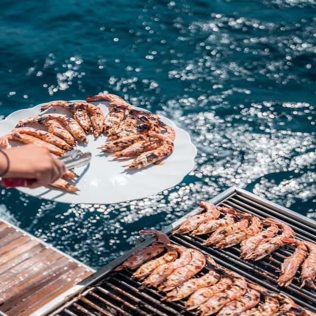 Santorini: Majestic Catamaran Cruise with Meal and Drinks - Volcanic beaches, the caldera, and the hot springs