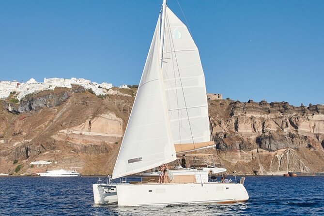 Santorini Platinum Catamaran Cruise with Meal, BBQ and Open Bar - Red Beach begins the coastal show