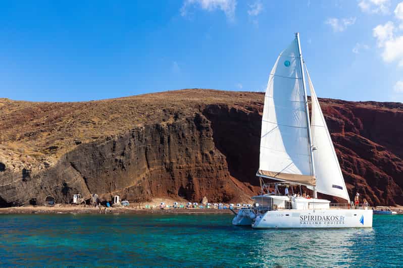Santorini: Sailing Catamaran Cruise with BBQ and Drinks - Red Beach and the pale volcanic coast